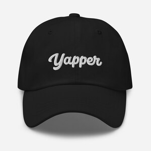 May include: Black baseball cap with the word "Yapper" embroidered in white script across the front. The cap has a curved brim and a structured fit. A classic, casual accessory.