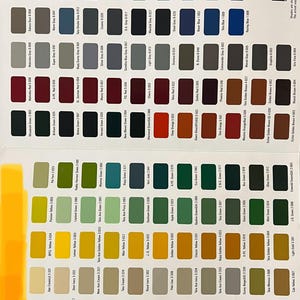 May include: A color chart displaying a variety of paint swatches, each labeled with a unique name and code. The palette includes shades of blue, green, red, yellow, gray, and white, suitable for automotive or industrial applications.