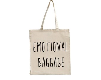 May include: A beige canvas tote bag with black text that reads "Emotional Baggage".