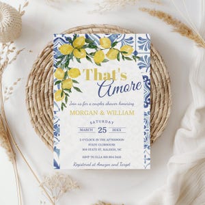 May include: A white invitation with blue and yellow accents. The invitation is for a couples shower honoring Morgan and William. The invitation includes the date, time, and location of the shower. The invitation also includes the RSVP information and the registry information.