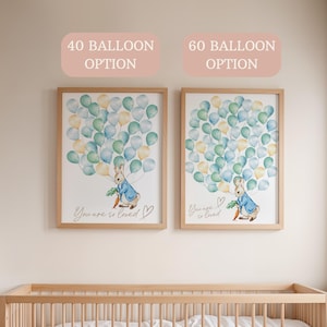 May include: Two framed prints with a watercolor illustration of a rabbit holding a carrot and surrounded by balloons. The text "You are so loved" is written below the rabbit. The top of each frame has a text label: "40 Balloon Option" and "60 Balloon Option".