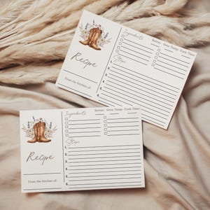 May include: Two recipe cards with a rustic design. Each card features a watercolor illustration of cowboy boots and floral accents. The cards include sections for ingredients, steps, and kitchen details.