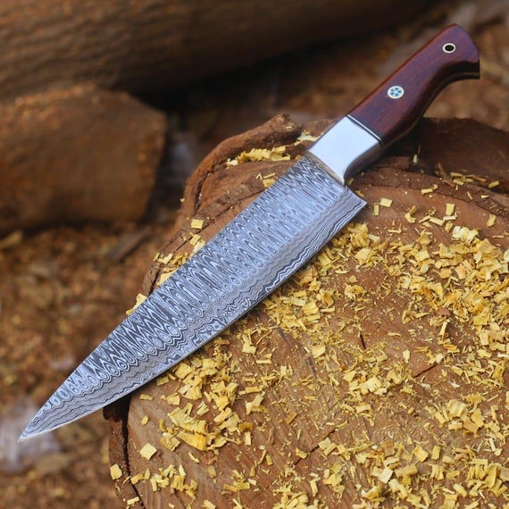 Hand-forged Damascus steel chef knife with the swirling layered-metal pattern that makes every blade genuinely one-of-a-kind — functional art for the kitchen.