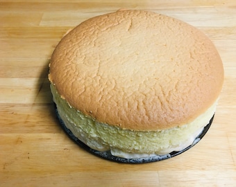 May include: A light brown Japanese cheesecake with a slightly browned top and a soft, fluffy texture.