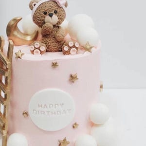 Bear themed fondant covered birthday cake/brown ,pink and gold color themed birthday