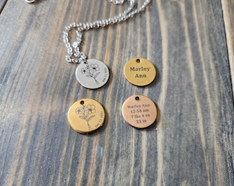May include: Three round silver, gold, and rose gold pendants with engraved floral designs and text. The silver pendant reads "Feb 11, 2021". The gold pendant reads "Feb 11, 2021". The rose gold pendant reads "Marley Ann 12:58 am 7 lbs 4 oz 21 in".