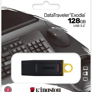 May include: A black USB flash drive with a gold cap. The drive is labelled "Kingston" and "128GB". The packaging shows the drive plugged into a computer with a mouse and keyboard. The text on the packaging reads "DataTraveler Exodia 128GB USB 3.2+"