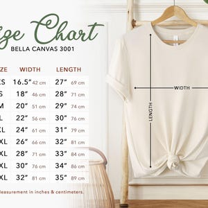 May include: A cream-colored t-shirt hangs on a wooden hanger, with a size chart to the left. The chart lists sizes XS to 5XL, with measurements in inches and centimeters. The text "Size Chart" is at the top.