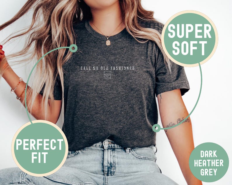 May include: Dark heather grey t-shirt with the text "Call Me Old Fashioned" and a small graphic of a cocktail glass. The shirt is described as "Super Soft" and a "Perfect Fit".