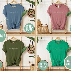 May include: Four t-shirts in steel blue, heather mauve, olive, and heather kelly green, each with the text "FALL SA BLE FASHIONED" in white. The shirts are displayed on wooden hangers, with the words "DURABLE" and "GREAT MATERIAL" in circles.