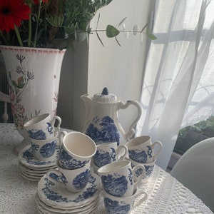 Vintage French coffee service from Sarreguemines. Blue and white. 6 coffee cups and 6 saucers with country scenes.