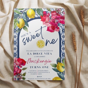 Peut inclure: Une invitation blanche avec une bordure de carreaux bleus et blancs. L'invitation dit "She's a Sweet One" avec une illustration de citron. Le texte dit &eacute;galement "Please join us to celebrate La Dolce Vita La Bellissima Mackenzie Turns One" avec des d&eacute;tails pour l'&eacute;v&eacute;nement.