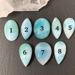 Peut inclure: Huit cabochons de pierres pr&eacute;cieuses bleues et blanches de diff&eacute;rentes tailles et formes, num&eacute;rot&eacute;s de 1 &agrave; 8.