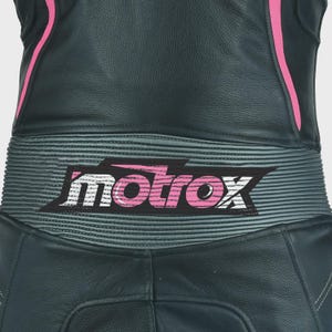 May include: Black leather motorcycle suit with pink accents and a gray and white "motrox" logo on the back.