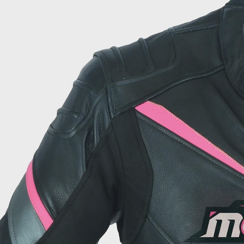 May include: Black leather motorcycle jacket with pink accents and a logo on the lower right side. The jacket has a padded shoulder and a zippered front closure.