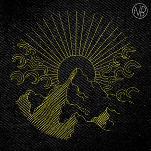 May include: Yellow embroidered mountain and sun design on a black denim background. The design features a sunburst, stylized mountains, and cloud-like shapes. The initials "NB" are in a circle in the upper right corner.
