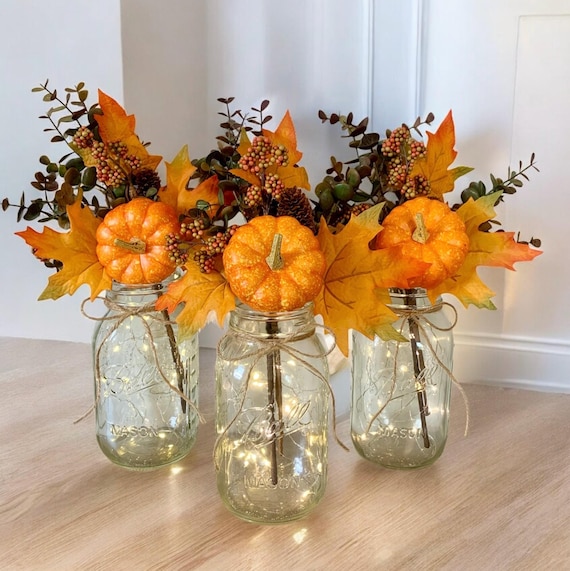 spring dining table decor: pastels, wildflowers, linen, mason jars; fall decor: pumpkins, cinnamon sticks, rustic wood