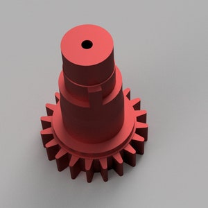 Puede incluir: Un engranaje de metal rojo con un eje cil&iacute;ndrico. El engranaje tiene un gran n&uacute;mero de dientes y est&aacute; dise&ntilde;ado para su uso en un sistema mec&aacute;nico.