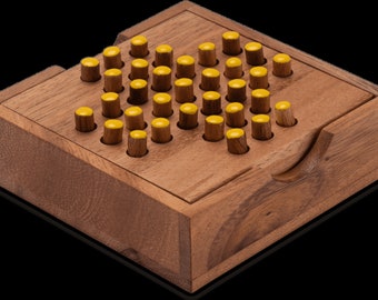May include: A wooden game with a sliding lid. The game board has a grid of holes with yellow-tipped pegs in each hole.
