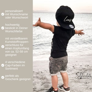 May include: A black baseball cap with the name "Luis" in white script. The cap is worn by a child on a beach, paired with a black t-shirt and gray shorts. The cap is adjustable and fits a head circumference of approximately 20.5-23 inches.