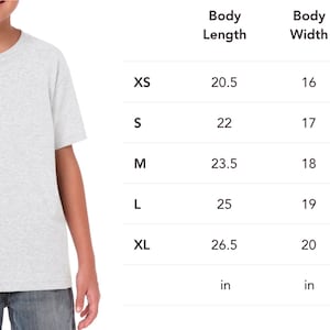 May include: A light gray t-shirt with a crew neck, worn by a child. The image includes a size chart with measurements in inches for body length, width, and sleeve center back for sizes XS to XL.