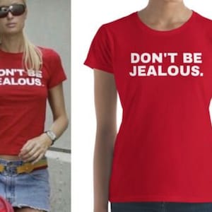 May include: Red t-shirt with white text that reads "Don't Be Jealous."