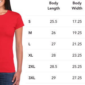 May include: A red t-shirt is modeled by a person, with a size chart displayed to the right. The chart lists body length, width, and sleeve center back measurements in inches for sizes S through 3XL.