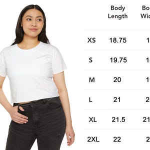 May include: A white, short-sleeved crop top. The image includes a size chart with body length and width measurements in inches for sizes XS to 2XL. The model is wearing the crop top and black jeans.