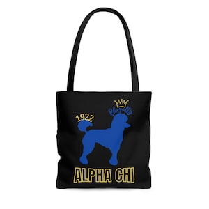 May include: Black tote bag with a blue poodle silhouette, a gold crown, and the text "Royalty" in blue. The bag also features the text "1922" and "ALPHA CHI" in gold.