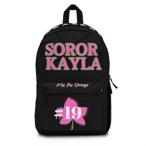 May include: Black backpack with the text "SOROR KAYLA" in pink and green. The backpack has a front pocket with a pink leaf design and the number "19". The words "Mu Nu Omega" are also on the backpack.