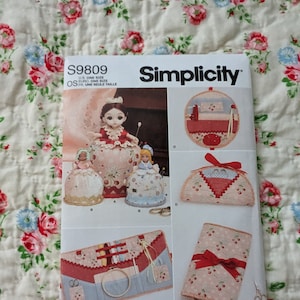 May include: Simplicity sewing pattern number S9809 for making a pincushion, needle case, and a small sewing kit. The pattern includes instructions for making three different styles of pincushions, a needle case, and a small sewing kit. The pattern is designed and printed in the USA.