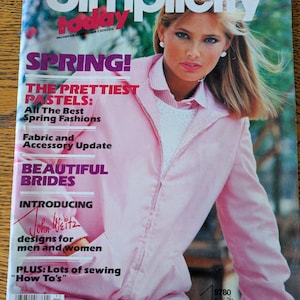 May include: A magazine cover for Simplicity magazine, featuring a woman wearing a pink jacket and white pants. The cover text reads "Spring! The Prettiest Pastels: All The Best Spring Fashions, Fabric and Accessory Update, Beautiful Brides, Introducing John Weitz designs for men and women, PLUS: Lots of sewing "How To's""