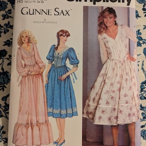 May include: Simplicity sewing pattern S3213 with Gunne Sax designs. The pattern shows illustrations of vintage dresses in pink, blue, and white floral fabrics. The pattern size is U.S. 6-14, Euro 32-40, and French 34-42.