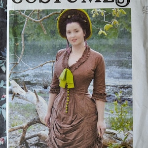 May include: McCall's Costumes pattern featuring a woman in a brown dress with a yellow bow and hat. The pattern cover includes the text "McCall's Costumes" and the designer's name, Angela Clayton.