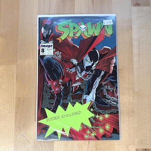 May include: Comic book cover for Spawn #8, featuring a masked character in a red cape and black suit. The title "Spawn" is in green and white. The cover includes the text "Poster Enclosed".