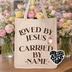 Natural cotton canvas tote featuring three illustrated ducks wearing pink bows with text “GETTING MY ducks in a row FOR HIS RETURN” on front and personalized back reading “LOVED BY JESUS CARRIED BY – NAME –”, customizable Christian church tote gift for mom, friend, teacher, or teen girl.
