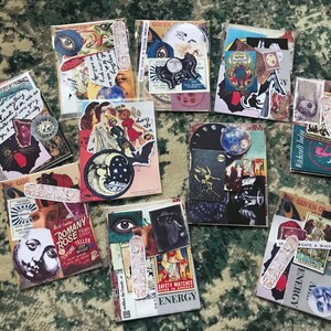 May include: A collection of nine collage cards featuring various images and text. The cards are decorated with a variety of images, including moons, stars, eyes, and other mystical symbols. The text on the cards includes phrases like "Witchcraft Today", "Queen of", "Weave a Magic Spell", and "Energy".