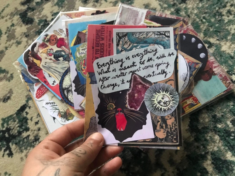 May include: A collection of vintage ephemera and stickers featuring a black cat with red eyes, a sun with a face, and a quote that reads "Everything is everything. What is meant to be, will be. After winter must come spring. Change, it a... eventually."