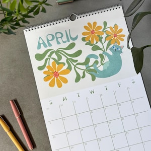 2026 Wall Calendar featuring silly, cute cats and retro flowers. This calendar is January - December 12 month dated and illustrated. It has a wire spiral hanger.