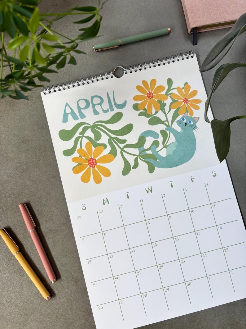 2026 Wall Calendar featuring silly, cute cats and retro flowers. This calendar is January - December 12 month dated and illustrated. It has a wire spiral hanger.