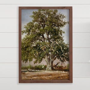 May include: A framed landscape painting of a large, mature tree with a sprawling canopy of green leaves. The tree's trunk is thick and gnarled, with exposed roots. The painting has a brown wooden frame and a muted color palette.