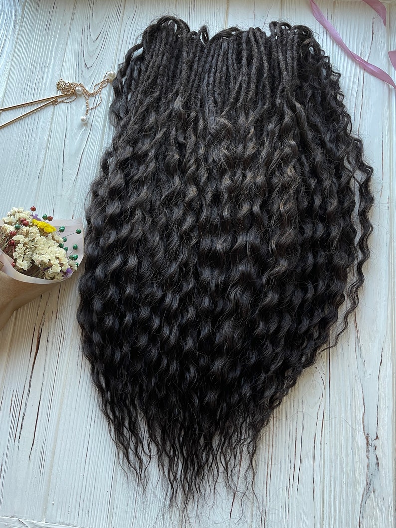 May include: A set of long, dark brown curly dreadlocks. The dreadlocks are arranged in a loose, flowing style.