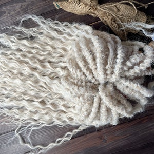 May include: A long, white, curly wig with a thick, textured braid. The wig is made of synthetic fibers and is perfect for adding volume and length to your hair.