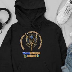 May include: Black hooded sweatshirt with a gold and blue graphic design. The graphic features a winged staff with an eye and a diamond. The text "Vision Today, Victory Tomorrow" is in a circle around the staff. The text "Ward Planters United" is below the staff.