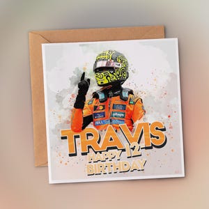 May include: A birthday card featuring a watercolor-style illustration of a race car driver in an orange and black uniform and helmet. The card reads "Travis Happy 12th Birthday" in orange and black text.