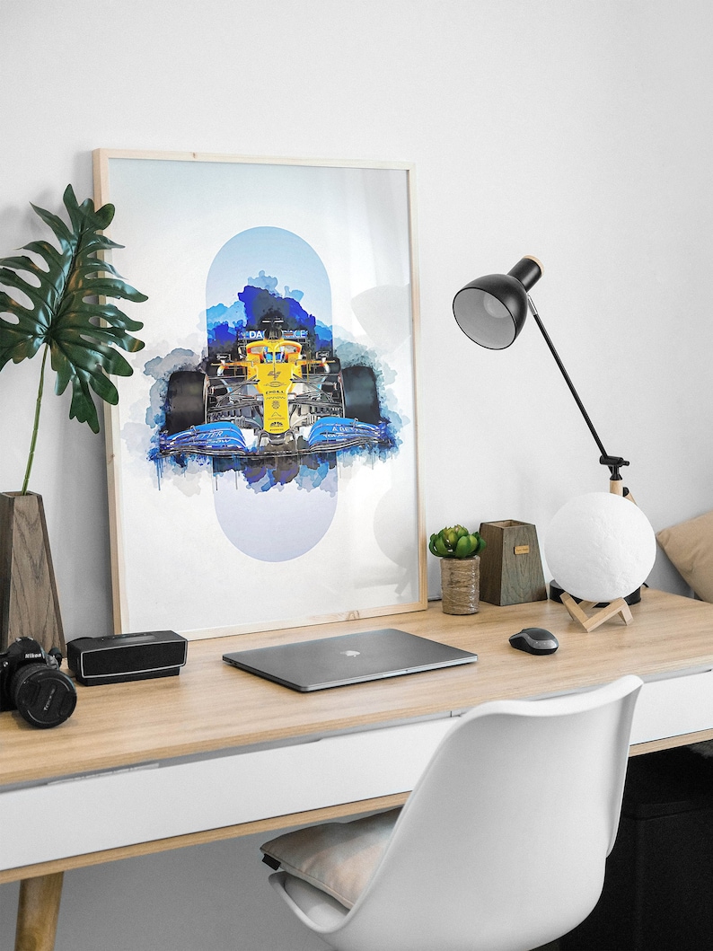 May include: A framed watercolor print of a Formula 1 race car in blue, yellow, and black. The car is surrounded by a blue and white watercolor background.