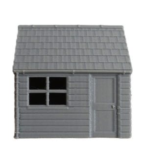 May include: A miniature gray shed model with a sloped, shingled roof, a small window with four panes, and a door. The shed's exterior features horizontal siding. The model is designed for hobbyists and model train enthusiasts.