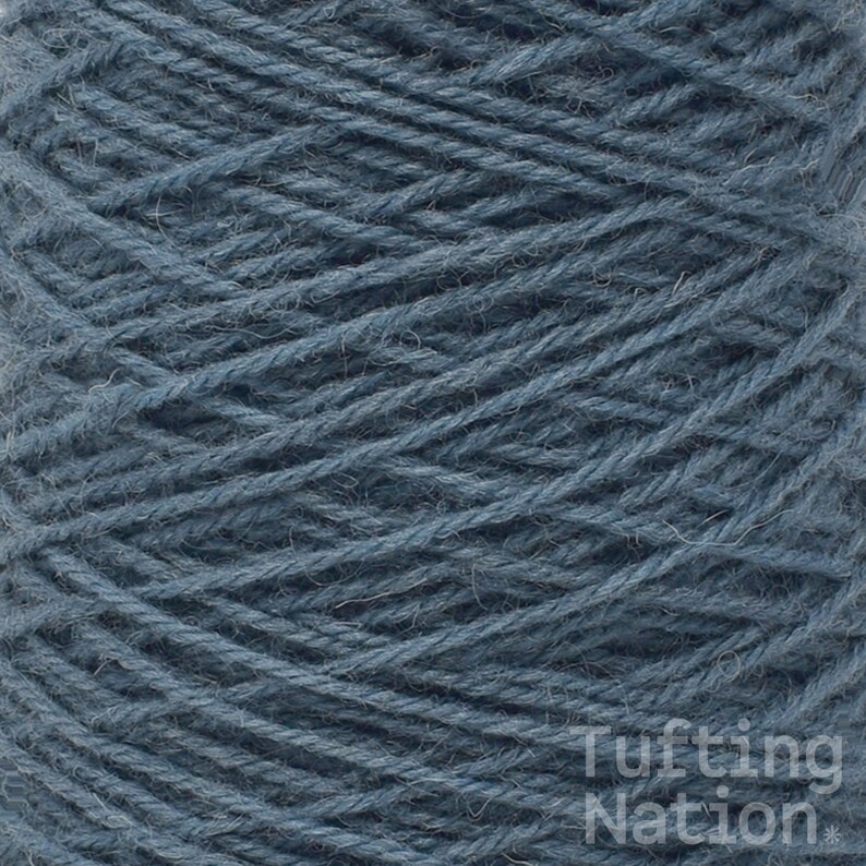 May include: A close-up of a skein of blue yarn. The yarn is made of wool and is a medium weight. It is perfect for knitting or crocheting.
