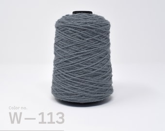 May include: A spool of gray wool yarn, labeled "Color no. W-113".