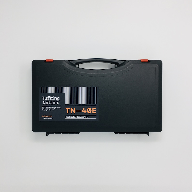 May include: Black hard-shell carrying case with a red latch. The case has a label that says "Tufting Nation. Supplies for Rug Makers tuftingnation.com" and "TN-40E Electric Rug Carving Tool".